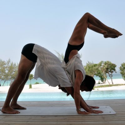 partner yoga, scorpion-on-dog pose partner yoga, scorpion-on-dog pose